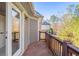 A view from the deck with wood railing overlooking trees and a neighboring home at 1526 Rocky River Dr, Lawrenceville, GA 30045