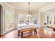 Bright dining area with hardwood floors, table with bench, and view of outdoor greenery at 1526 Rocky River Dr, Lawrenceville, GA 30045