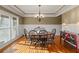 Bright dining room with a wood table, wainscoting, and large windows at 1526 Rocky River Dr, Lawrenceville, GA 30045