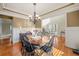 Elegant dining room featuring a wood table, chandelier, and stylish decor at 1526 Rocky River Dr, Lawrenceville, GA 30045