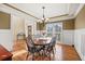 Elegant dining room with wainscoting, a stylish chandelier, and hardwood flooring at 1526 Rocky River Dr, Lawrenceville, GA 30045