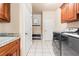 Functional laundry room with modern washer and dryer and built-in cabinets for storage at 1526 Rocky River Dr, Lawrenceville, GA 30045