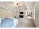 Expansive main bedroom with tray ceiling, plush carpet, and connecting en suite bathroom at 1526 Rocky River Dr, Lawrenceville, GA 30045