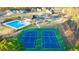 An aerial view of a neighborhood pool and tennis courts in a well maintained residential community at 1808 Lacebark Elm Way, Lawrenceville, GA 30045