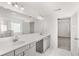 Bathroom featuring double vanity, quartz countertops, and a glass enclosed shower at 1808 Lacebark Elm Way, Lawrenceville, GA 30045