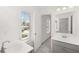 Bathroom featuring double sinks, tile floor and natural light at 1808 Lacebark Elm Way, Lawrenceville, GA 30045