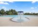 An inviting community pool with a central fountain feature on a sunny day at 1808 Lacebark Elm Way, Lawrenceville, GA 30045