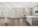 Open concept view of kitchen with island, stainless appliances, and natural lighting at 1808 Lacebark Elm Way, Lawrenceville, GA 30045