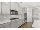 Modern kitchen features stainless steel appliances and gray cabinets with white countertops at 1808 Lacebark Elm Way, Lawrenceville, GA 30045