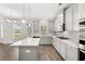 Modern kitchen features stainless steel appliances, an island, and gray cabinets with white countertops at 1808 Lacebark Elm Way, Lawrenceville, GA 30045