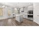 Eat-in kitchen with stainless steel appliances, island, subway tile, and gray cabinetry at 1808 Lacebark Elm Way, Lawrenceville, GA 30045