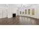 Living room features a fireplace, ceiling fan, and natural lighting from a set of five windows at 1808 Lacebark Elm Way, Lawrenceville, GA 30045