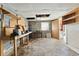 Unfinished basement with workbench, shelving, exposed wiring and concrete floor at 202 Neely Rd, Fayetteville, GA 30214