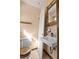 Modest bathroom featuring a sink, toilet and aged-wood mirror at 202 Neely Rd, Fayetteville, GA 30214