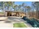 Single-story home featuring a spacious carport and surrounded by lush greenery at 202 Neely Rd, Fayetteville, GA 30214