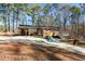 Cabin home featuring a long driveway, ample parking and mature trees at 202 Neely Rd, Fayetteville, GA 30214