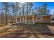 Single-story home with a covered front porch and a partially brick exterior with trees around the property at 202 Neely Rd, Fayetteville, GA 30214