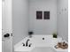 Bright bathroom features a soaking tub with modern fixtures and decor at 185 Bob White Dr, Stockbridge, GA 30281
