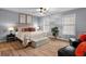 Spacious bedroom featuring modern furnishings, a ceiling fan, and comfortable seating area at 185 Bob White Dr, Stockbridge, GA 30281