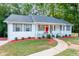Beautiful one-story home showcasing a red front door, white exterior, and well-maintained landscaping at 185 Bob White Dr, Stockbridge, GA 30281