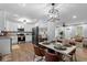 Bright kitchen featuring stainless steel appliances, white cabinets, and a stylish dining area at 185 Bob White Dr, Stockbridge, GA 30281