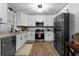 Modern kitchen showcasing granite countertops, stainless steel appliances, and white cabinetry at 185 Bob White Dr, Stockbridge, GA 30281