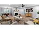 Open-concept living room featuring a stone fireplace, modern decor, and hardwood flooring at 185 Bob White Dr, Stockbridge, GA 30281