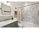 Bathroom featuring a marble-topped vanity and tiled shower and tub at 4351 Peachtree Dunwoody Ne Rd, Atlanta, GA 30342