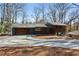 Contemporary home with a large driveway and modern wood and gray facade at 4351 Peachtree Dunwoody Ne Rd, Atlanta, GA 30342