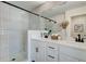 Modern bathroom with white double vanity, white tile shower, and neutral decor at 1932 Appian Aly, Kennesaw, GA 30144