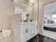 Modern bathroom with double sink vanity, glass shower, and elegant black tile flooring at 1932 Appian Aly, Kennesaw, GA 30144