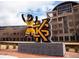 Kennesaw State University campus view with mascot in front of KSU logo and the academic building at 1932 Appian Aly, Kennesaw, GA 30144