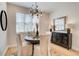 Dining room with modern chandelier, and a dark wood sideboard at 1932 Appian Aly, Kennesaw, GA 30144