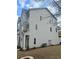 Side view of a modern townhome with gray siding, showcasing its well-maintained lawn at 1932 Appian Aly, Kennesaw, GA 30144