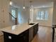 Well-lit kitchen with a large center island, stainless steel appliances, and hardwood floors at 1932 Appian Aly, Kennesaw, GA 30144