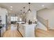 Bright, open kitchen with stainless steel appliances, large island and pendant lighting at 1932 Appian Aly, Kennesaw, GA 30144