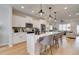 Bright, eat-in kitchen with white cabinets, stainless steel appliances, pendant lighting, and island with seating at 1932 Appian Aly, Kennesaw, GA 30144