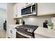 Close-up of a modern kitchen with white countertops and stainless steel appliances at 1932 Appian Aly, Kennesaw, GA 30144