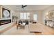 Open living space featuring a fireplace, ceiling fan, natural light, and a decorative rug at 1932 Appian Aly, Kennesaw, GA 30144