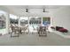 Chairs and tables fill the area next to the pool with a brick fireplace and a view of the water at 1932 Appian Aly, Kennesaw, GA 30144