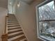 Bright staircase with wood and white trim leading to the upper level near a window at 1932 Appian Aly, Kennesaw, GA 30144