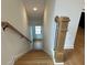 View of a wooden staircase with white risers and light wood handrail leading to a white front door at 1932 Appian Aly, Kennesaw, GA 30144