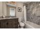 Bathroom with a granite countertop, gray tile, and a shower and tub combination at 2750 Old Horseshoe Bend Sw Rd, Marietta, GA 30064