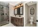 Bathroom with dual sink vanity, modern lighting, a walk-in shower with modern fixtures, and a toilet at 2750 Old Horseshoe Bend Sw Rd, Marietta, GA 30064