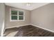 Empty bedroom featuring neutral paint, window with blinds, wood floors, and white baseboards at 2750 Old Horseshoe Bend Sw Rd, Marietta, GA 30064