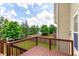 Wooden deck overlooking the yard, offering views of trees, fence and blue sky at 3455 Dalwood Dr, Suwanee, GA 30024