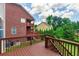 Back deck view of a brick house with a well maintained lawn and blue skies overhead at 3455 Dalwood Dr, Suwanee, GA 30024