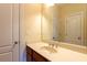 Bathroom vanity featuring a cream countertop, wood cabinetry, and a large mirror at 3455 Dalwood Dr, Suwanee, GA 30024