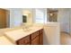 Bathroom vanity featuring a cream countertop, wood cabinetry, and a large mirror at 3455 Dalwood Dr, Suwanee, GA 30024