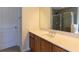 Bathroom vanity featuring a cream countertop, wood cabinetry, and a large mirror at 3455 Dalwood Dr, Suwanee, GA 30024